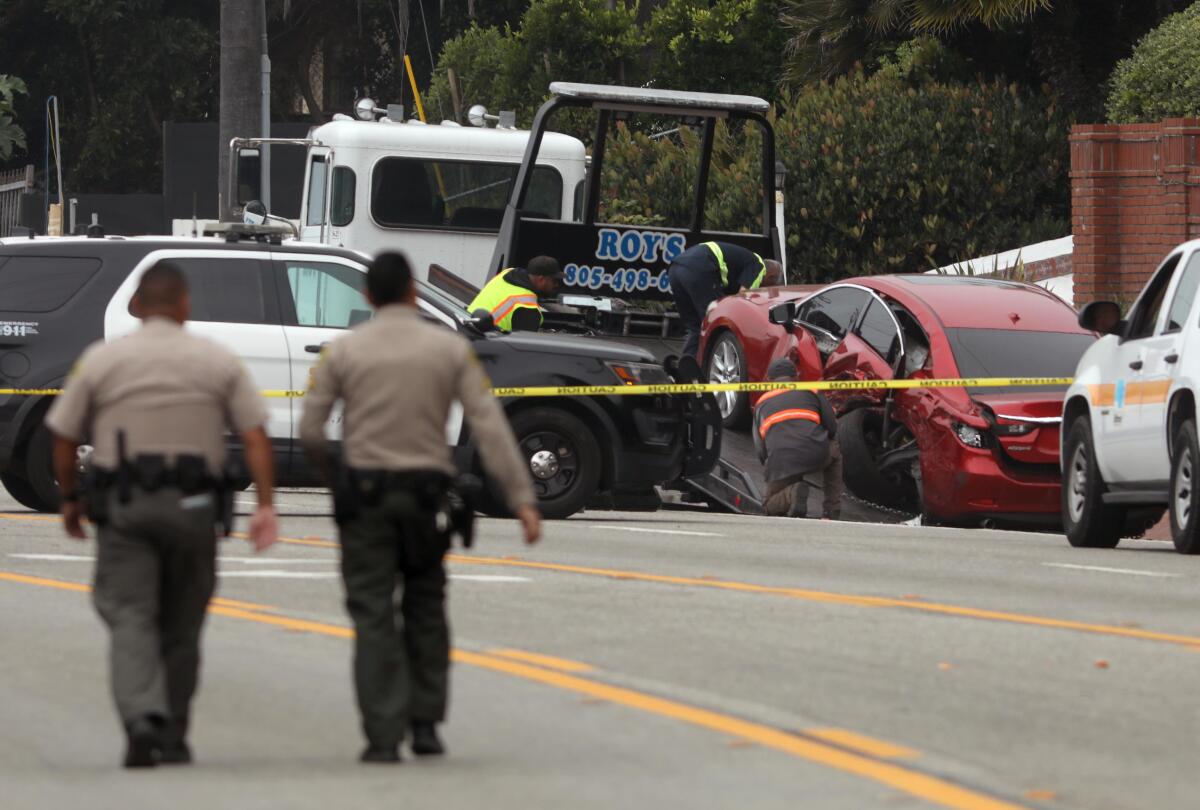 Sheriff's deputies approach the scene where four women were killed in a multi-vehicle crash in Malibu last week.