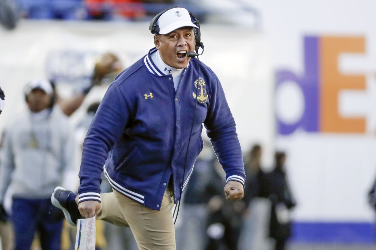 FILE - In this Dec. 31, 2019 file photo, Navy head coach Ken Niumatalolo cheers his team on in the first half of the Liberty Bowl NCAA college football game against Kansas State in Memphis, Tenn. For the first time since 1989, Navy and Brigham Young University will get together for a football game at the Naval Academy in Annapolis, Md., on Monday, Sept. 7, 2020. (AP Photo/Mark Humphrey, File)