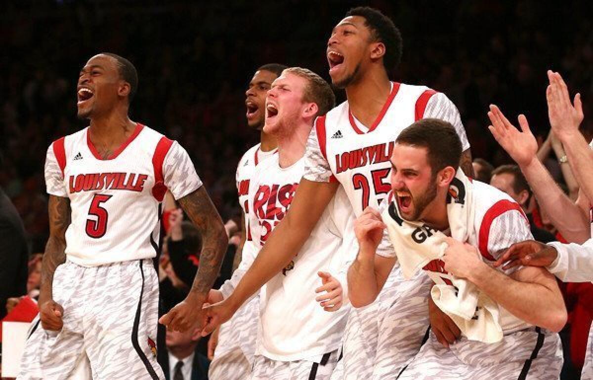Louisville players celebrate as the Cardinals close out a victory over Syracuse in the Big East Conference tournament final on Saturday.
