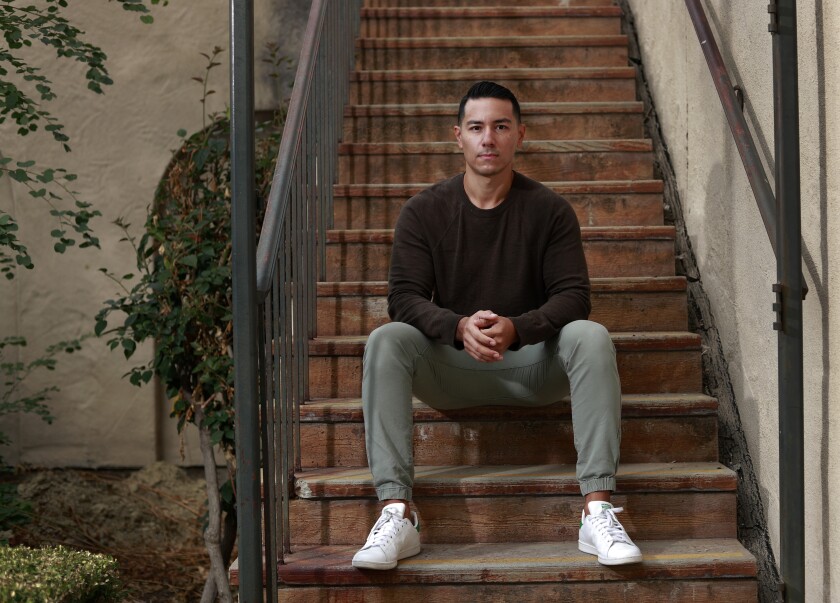 San Diego actor Steven Lone sits on the stairs near his San Diego home.