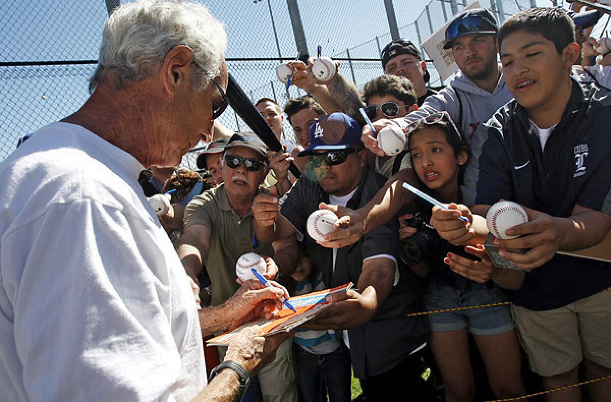 Hall of Fame Dodgers pitcher Sandy Koufax signs autographs for fans at Camelback Ranch at spring training last year.