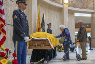 Long-time friend Kathy Flynn pauses at the casket of former New Mexico Gov, Bill Richardson as he lies in state in the rotunda of the New Mexico Capitol building, Wednesday, Sept. 13, 2023, in Santa Fe, N.M. (AP Photo/Roberto E. Rosales)