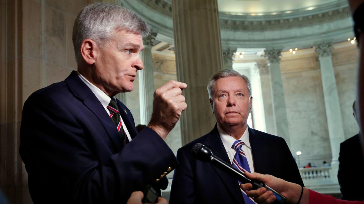 Sen. Bill Cassidy, R-La., left, and Sen. Lindsey Graham, R-S.C., talk about healthcare on Capitol Hill in Washington on July 13.