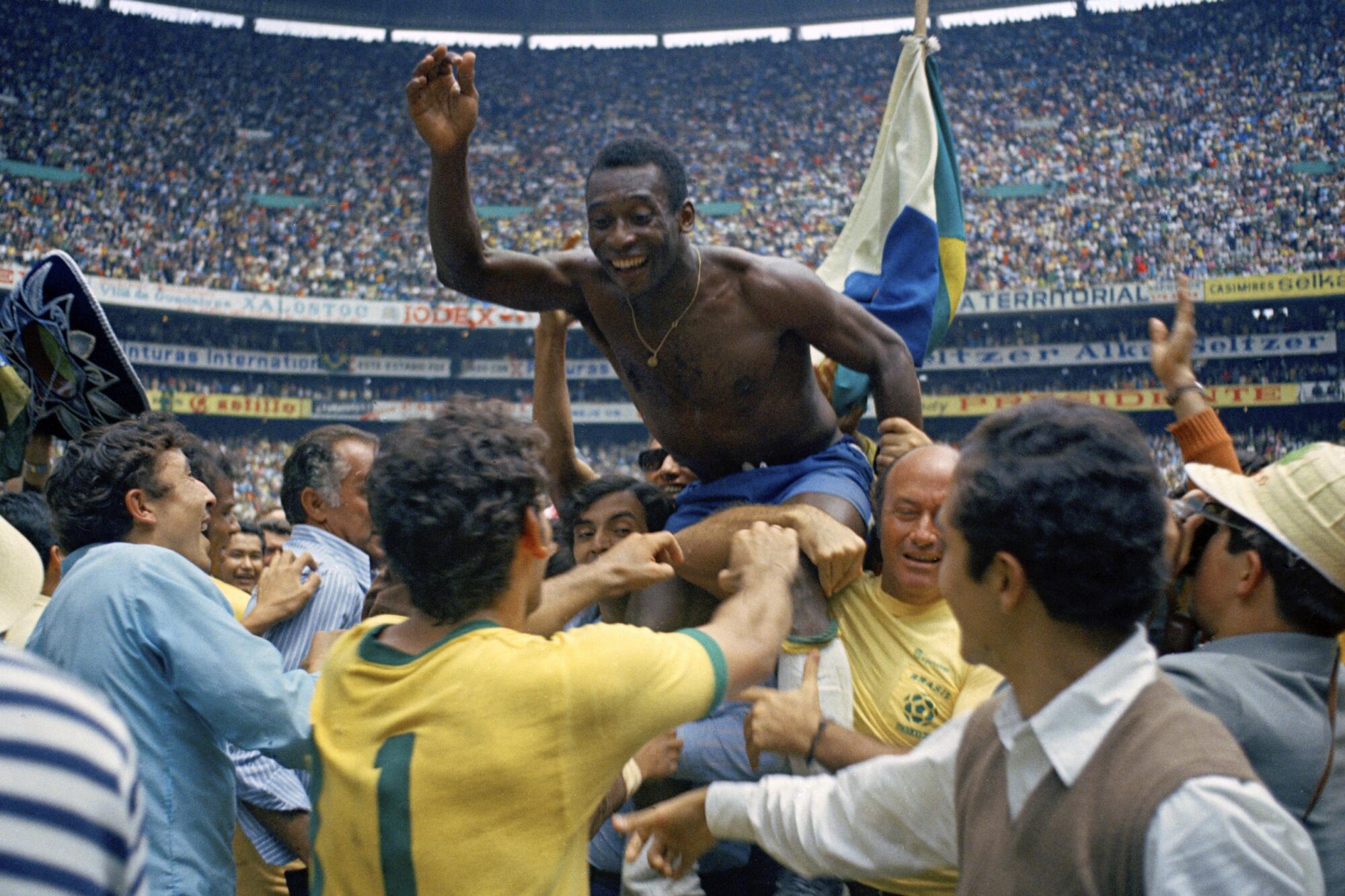 Pelé is carried off the field by his teammates after helping Brazil win the 1970 World Cup in a victory over Italy.