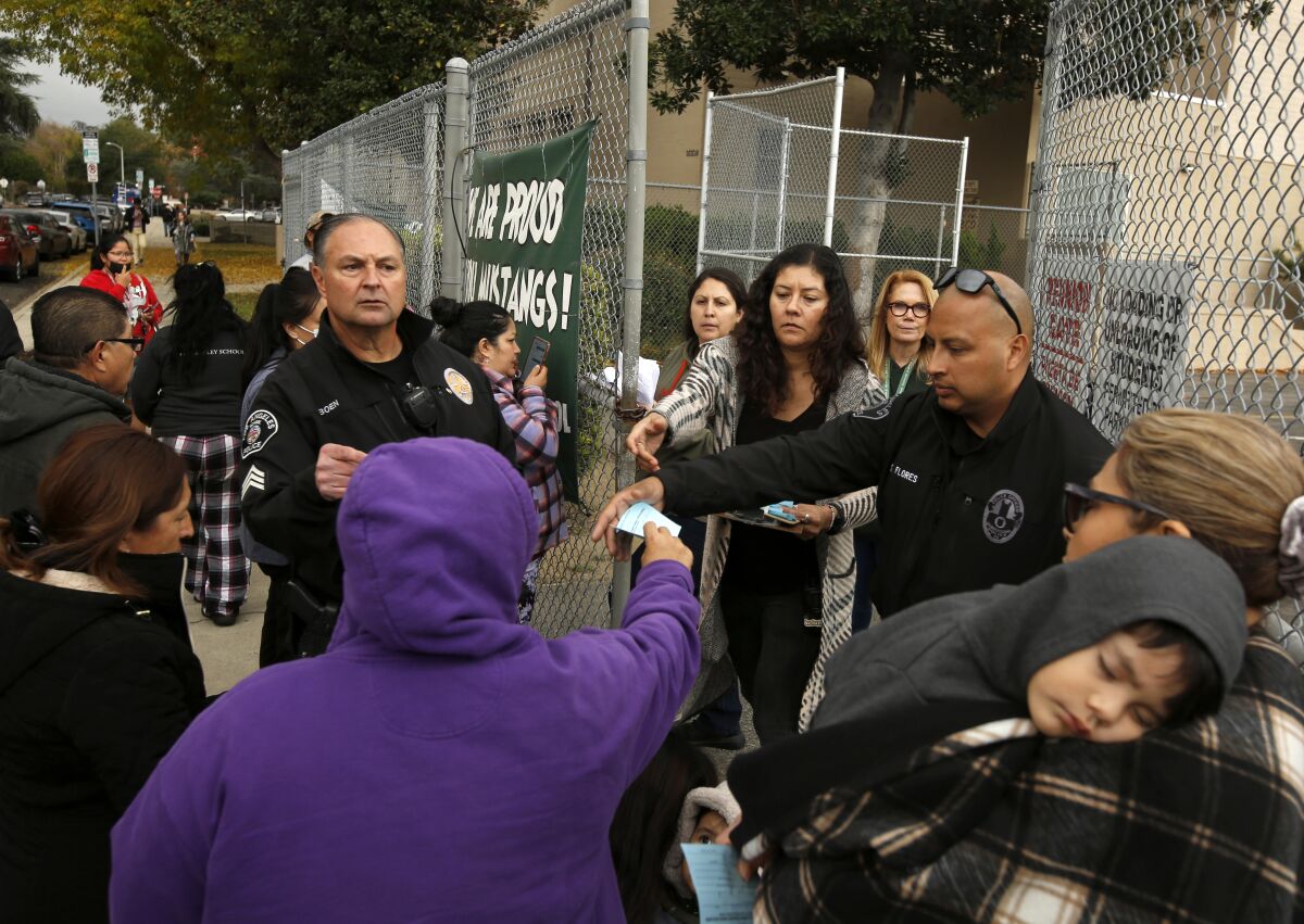 Parents wait to collect their children outside Van Nuys Middle School