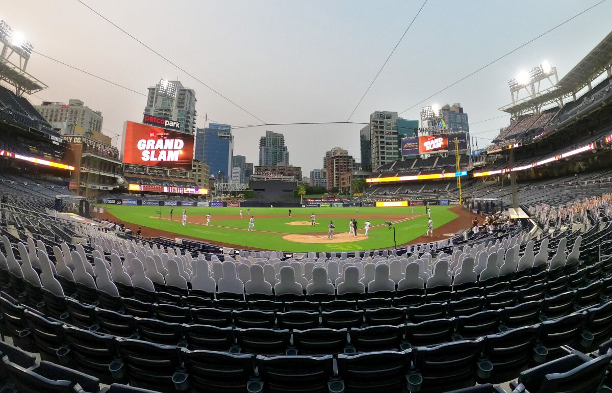 Cardboard cutouts remain seated as Padres' Wil Myers rounds bases following a grand slam Tuesday night at Petco Park.
