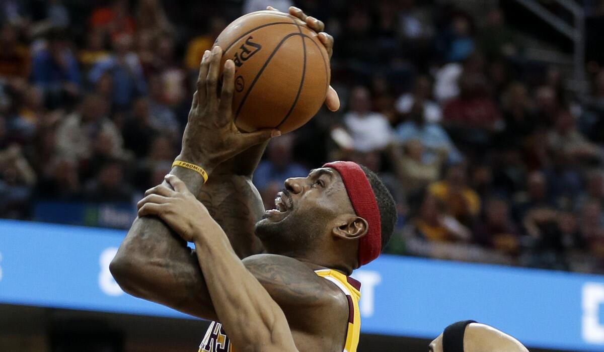 Cleveland Cavaliers' LeBron James is fouled while shooting for the basket in the first half on Thursday.