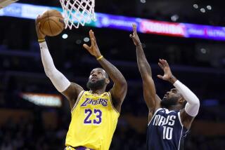 Los Angeles, CA - January 17: Lakers forward LeBron James, #23, left, goes up for a basket as Mavericks small forward Tim Hardaway Jr., #10 defends in the first half at Crypto.com Arena in Los Angeles Wednesday, Jan. 17, 2024. (Allen J. Schaben / Los Angeles Times)