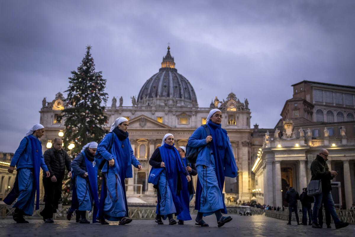 Nuns in blue arrive at dawn at St. Peter's Square