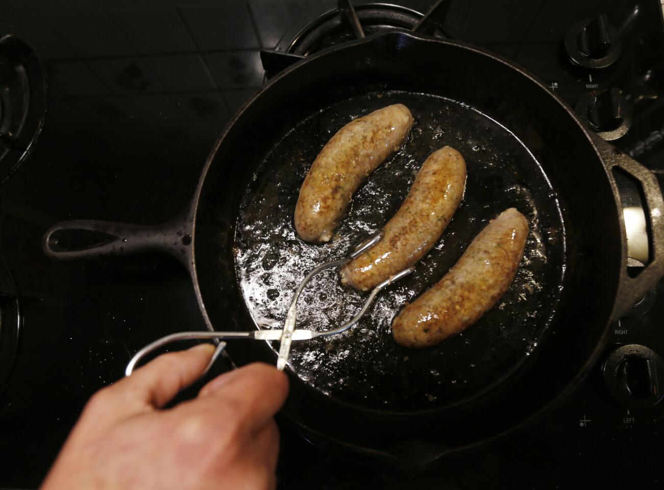 Links of Billy's Boudin are fried in a cast iron skillet in River Ridge, La., Tuesday, Jan. 26, 2016. Boudin is a tradition that dates back to the 1700s, when French Canadians came to Louisiana. Robert Carriker, a professor of history at the University of Louisiana in Lafayette, says Cajuns started using local ingredients and spices to make sausages that are different from Old World recipes. (AP Photo/Gerald Herbert)