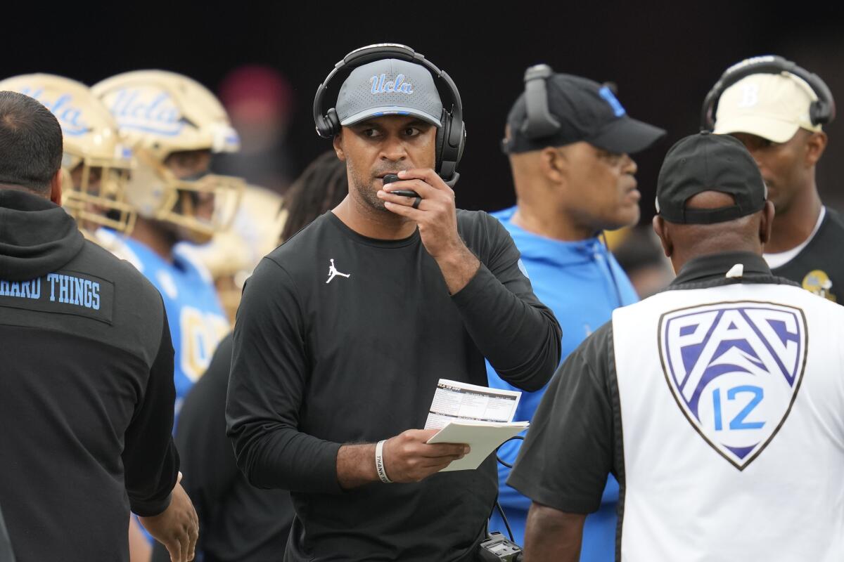 UCLA defensive coordinator D'Anton Lynn stands on the sideline during a timeout against USC at the Coliseum on Nov. 18.