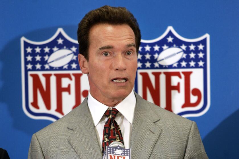 California Governor Arnold Schwarzenegger responds to a question during a press conference following a meeting with several NFL owners at the Dallas-Fort Worth International Airport in Grapevine, Texas, Tuesday, May 2, 2006. (AP Photo/Tony Gutierrez))