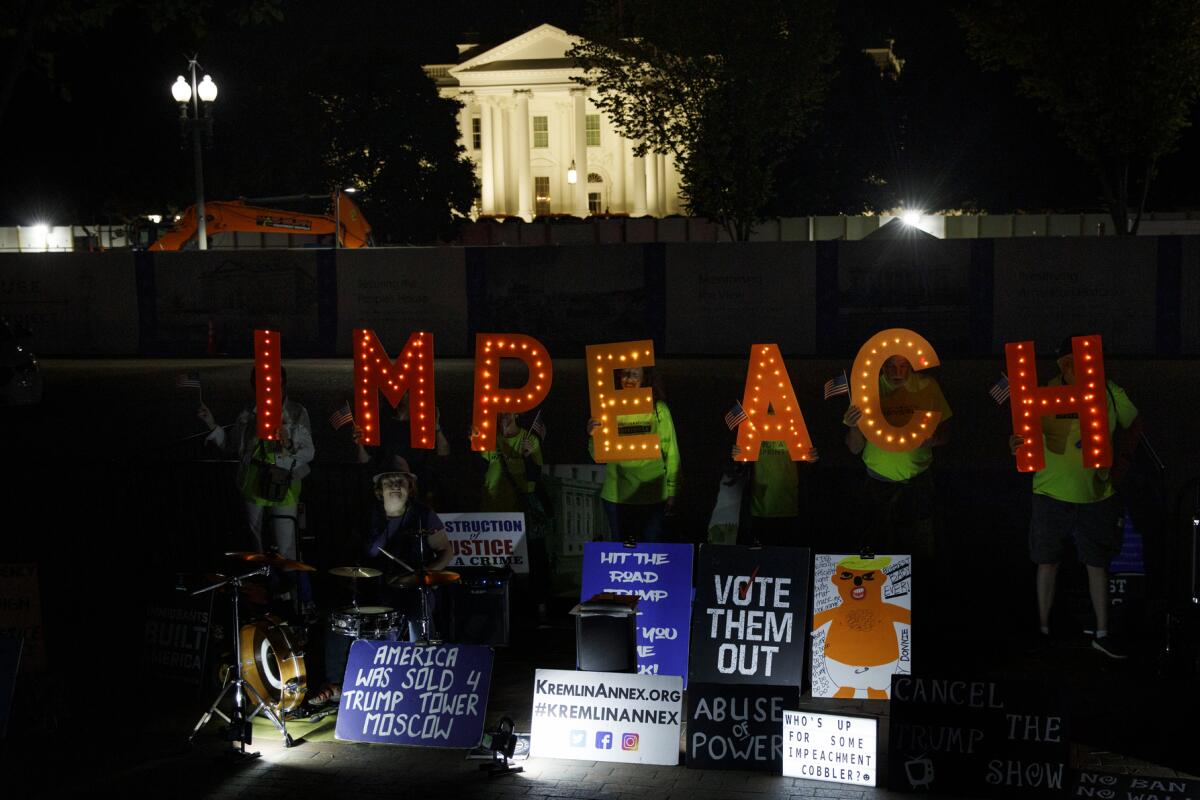 Protestors at the White House call for Trump's impeachment.