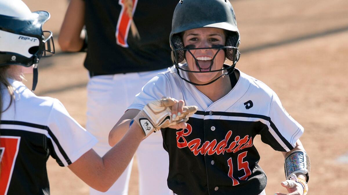 Beverly Bandits' Madison Ebeling celebrates a run on an overthrow during the 18U Premier bracket girls' Fastpitch Nationals championship game againt the Corona Angels on Friday.