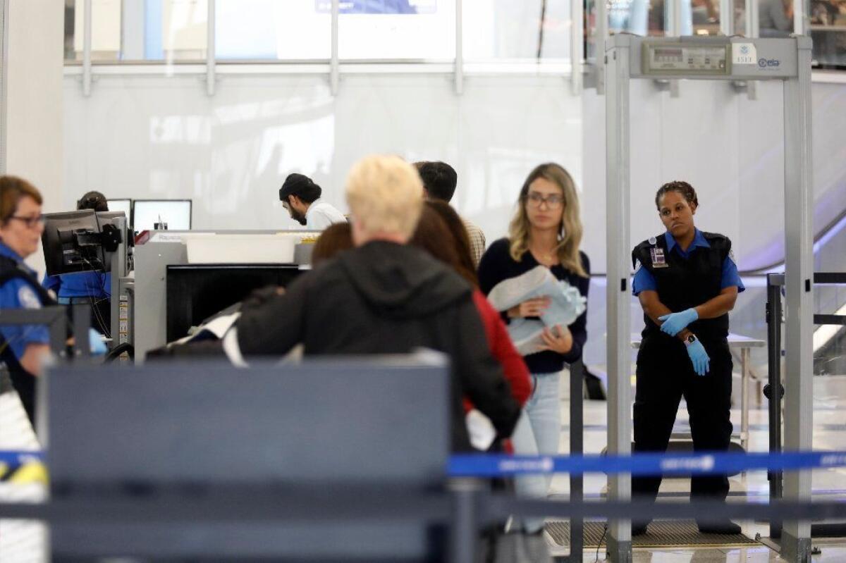 TSA agents check passengers for departure at Terminal 7 at the Los Angeles International Airport in January 2018.