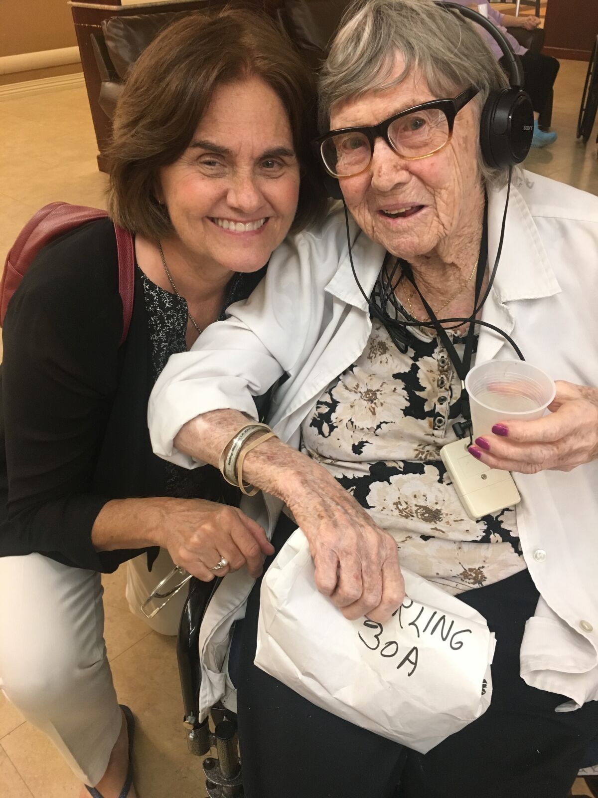 Jeannie Walsh (left) greets one of the senior citizens she's met through La Jolla Friendly Visitors.