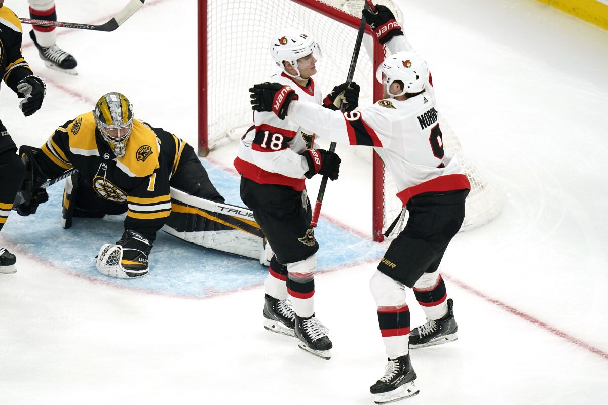 Ottawa Senators left wing Tim Stützle (18) is congratulated by Josh Norris, right, after his goal off Boston Bruins goaltender Jeremy Swayman (1) during the second period of an NHL hockey game, Thursday, April 14, 2022, in Boston. (AP Photo/Charles Krupa)