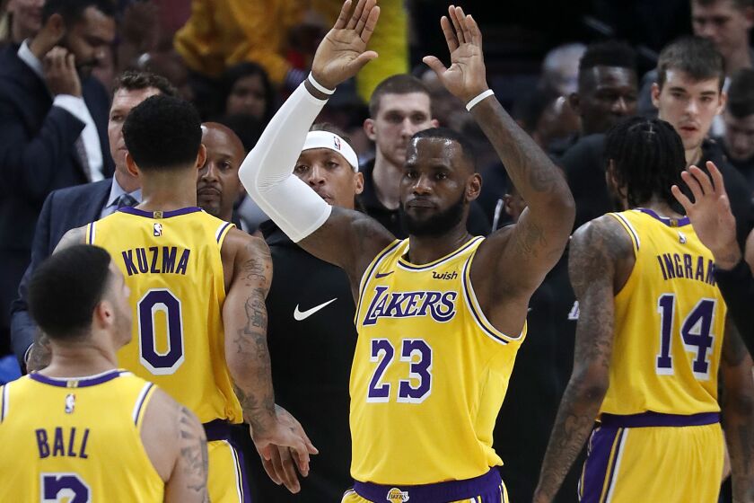 LeBron James celebrates a basket by Lakers guard Lonzo Ball against the Trail Blazers in the second quarter.