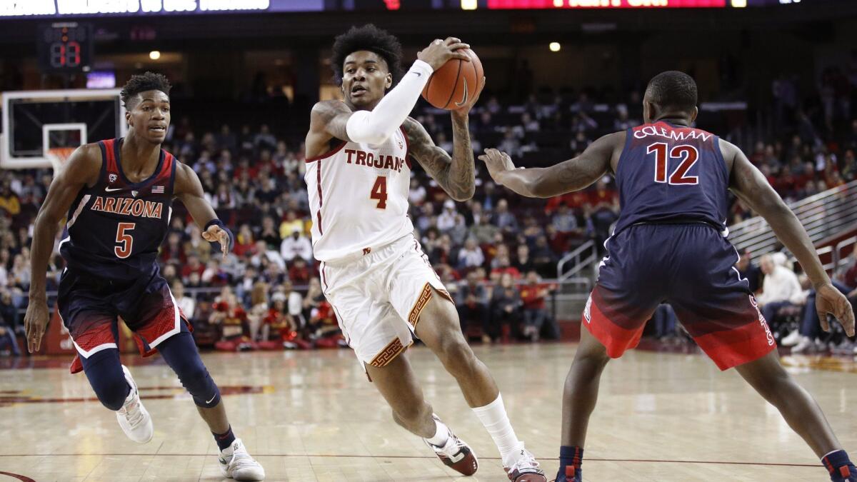 USC's Kevin Porter Jr., center, drives between Arizona's Brandon Randolph, left, and Justin Coleman during the first half.