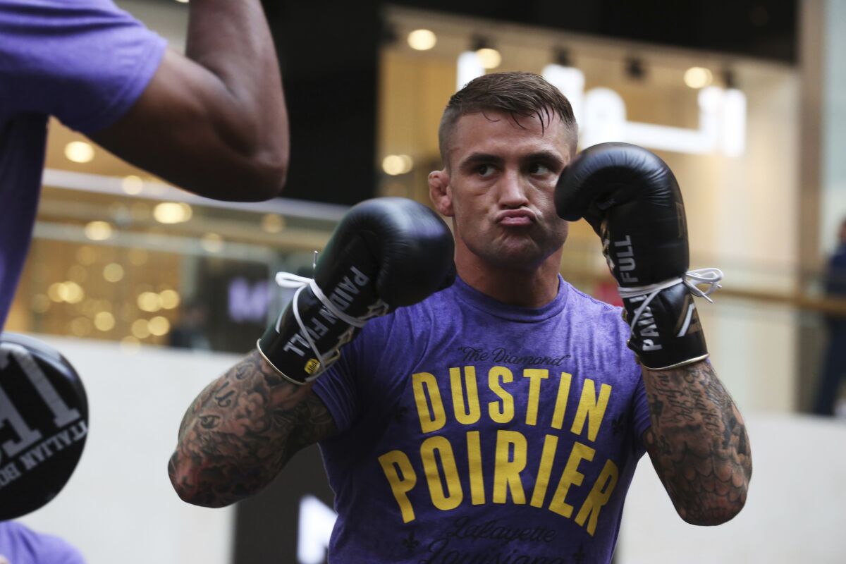 Dustin Poirier spars with a partner during an open training session at Yas Mall in Abu Dhabi.