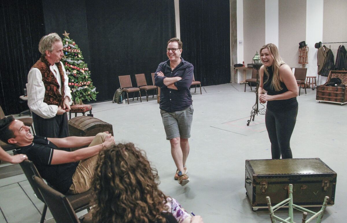 Co-writer and director Gordon Greenberg (center) chats with the cast during rehearsals for "Ebenezer Scrooge's Big San Diego Christmas Show" at the Old Globe.