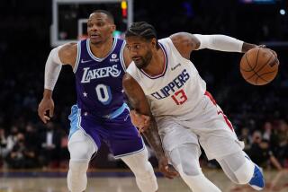 Los Angeles Lakers guard Russell Westbrook (0) defends against Los Angeles Clippers guard Paul George.