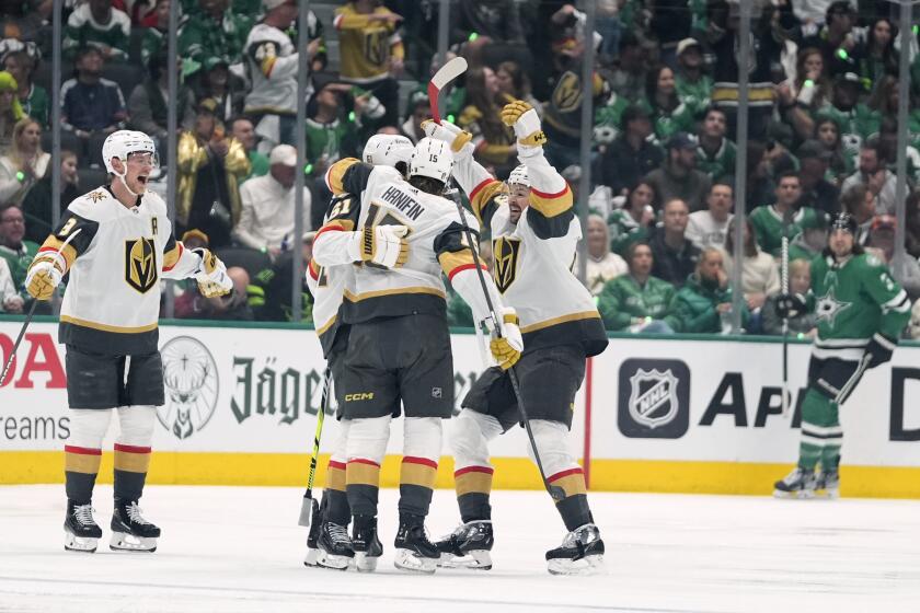 Vegas Golden Knights' Noah Hanifin (15) celebrates with Mark Stone (61), Tomas Hertl, front right, and Jack Eichel, left, after Stone scored in the first period in Game 1 of an NHL hockey Stanley Cup first-round playoff series against the Dallas Stars in Dallas, Monday, April 22, 2024. (AP Photo/Tony Gutierrez)