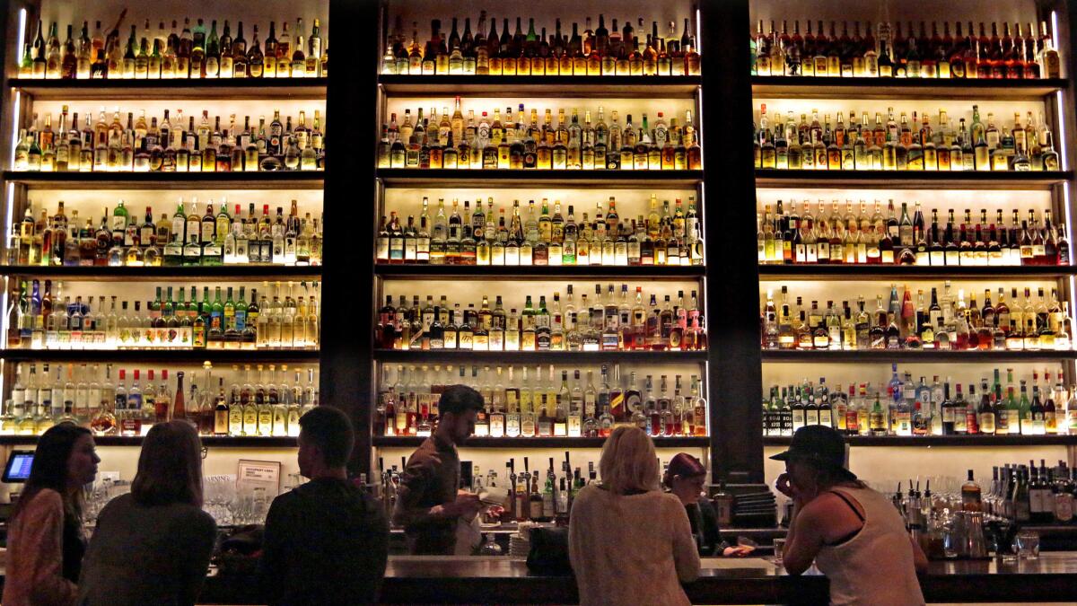The well-stocked bar at Scopa Italian Roots Restaurant in Venice. A service called BeMyDD offers professional drivers for hire to drive your own car.