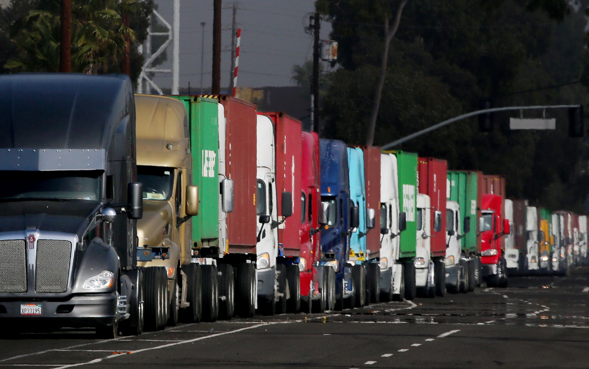 Trucks line up to enter the Evergreen Marine terminal in the Port of Los Angeles