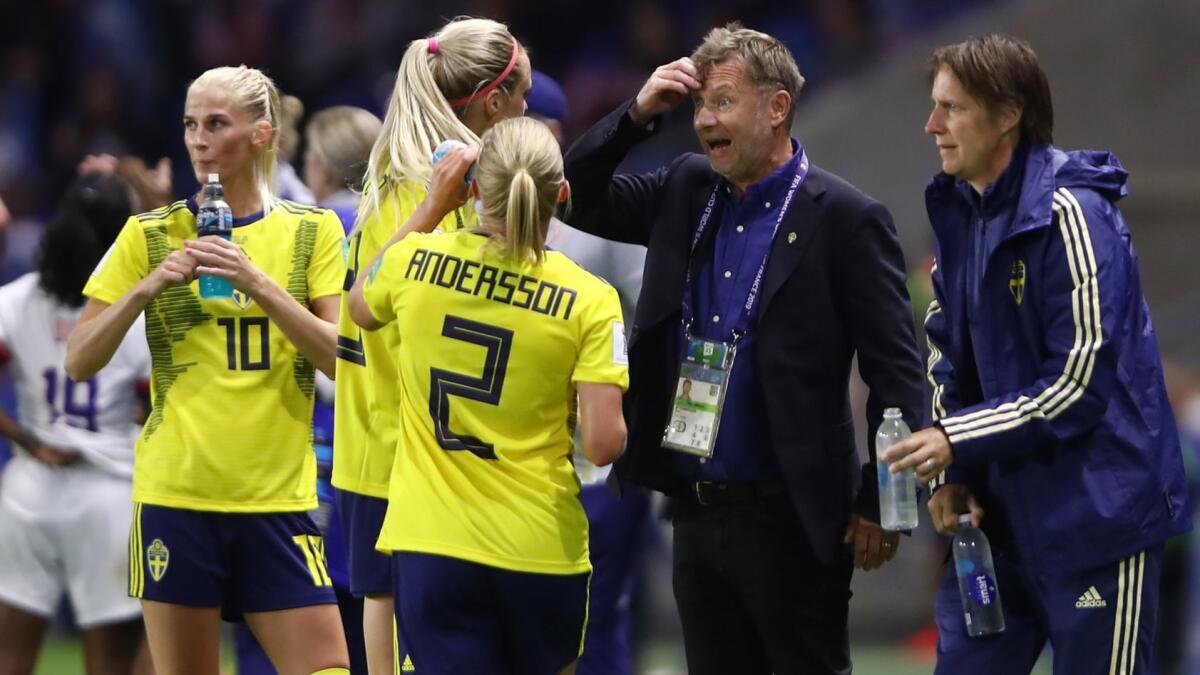 Sweden coach Peter Gerhardsson confers with players during Thursday's game agasint the United States on Friday.