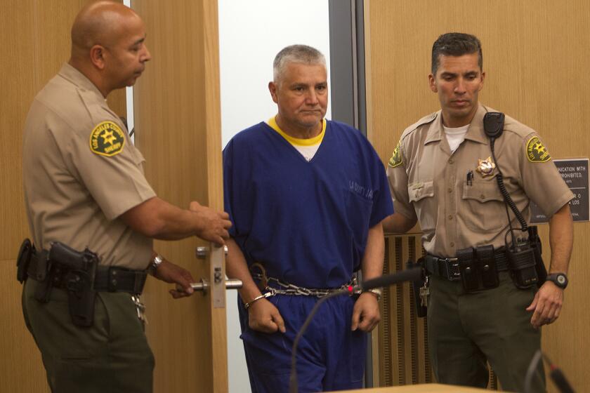 Sheriff deputies escort former LAUSD teacher Robert Pimentel into the courtroom, where he was sentenced to 12 years in prison for molesting students at George de la Torre Jr. Elementary School.