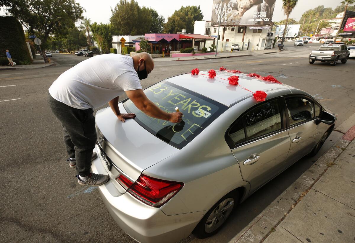 Walter Almendarez, who has worked as a bellman for 23 years, writes a message in support of Chateau Marmont workers.