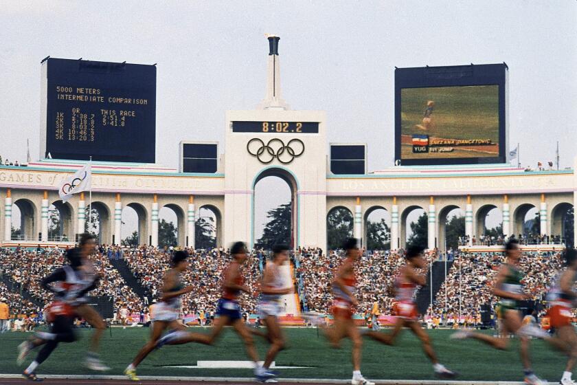 Runners compete in the men's 5,000 meters at the 1984 Los Angeles Summer Olympic Games at the Coliseum.