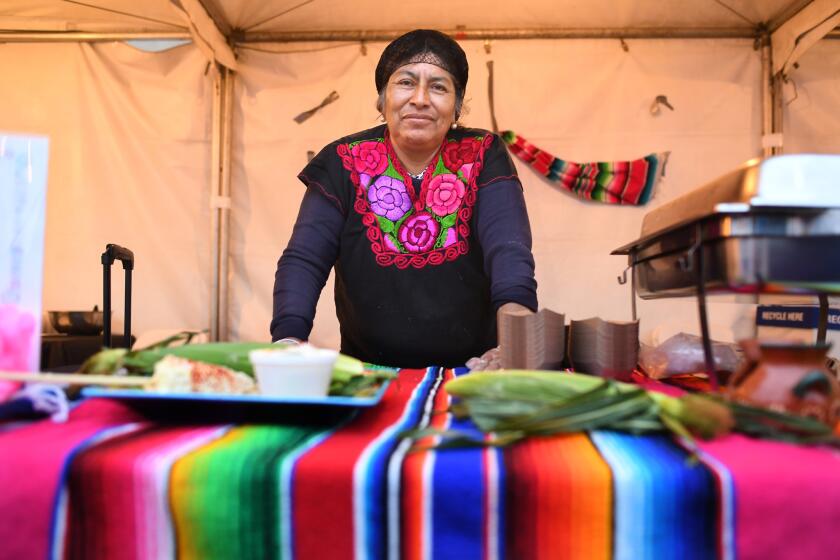 LOS ANGELES, CALIFORNIA MAY 24, 2018-Sidewalk vendor Merced Sanchez stands at her food booth at the Taste of Boyle Heights event recently. (Wally Skalij/Los Angeles Times)