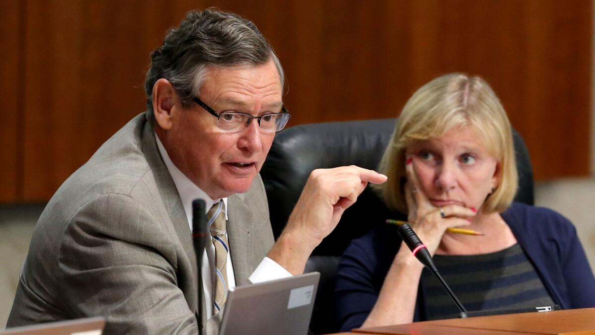 Cal State University Board of Trustees Chair Rebecca Eisen, right, listens to CSU Chancellor Timothy P. White speak during a meeting at CSU Chancellors Office in Long Beach on July 18.