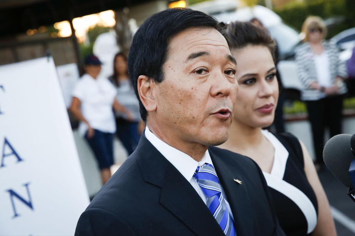 Retired Undersheriff Paul Tanaka, with wife Valerie Tanaka, speaks to reporters while awaiting results of the California primary race for Los Angeles County sheriff.