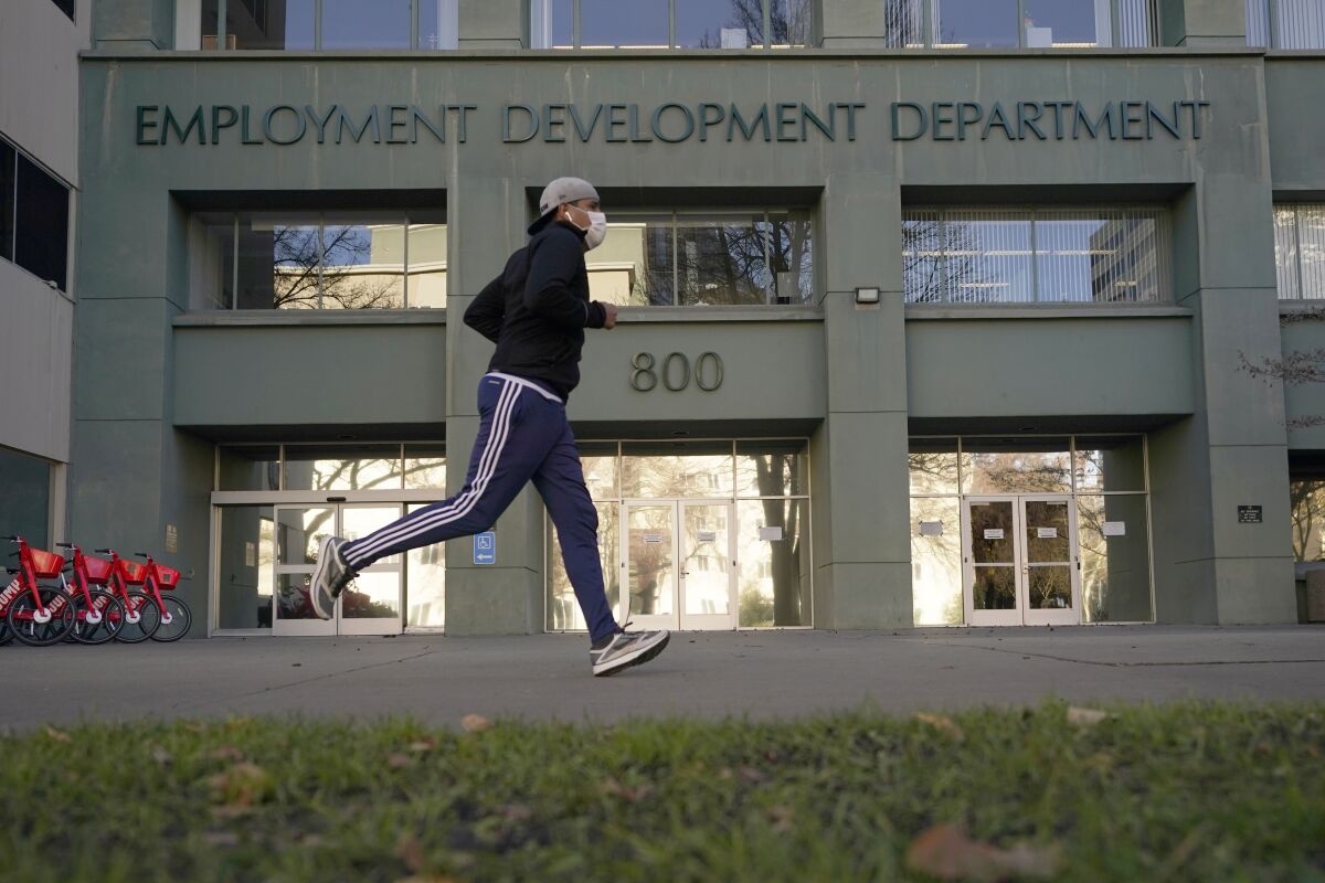 A runner passes the office of the California Employment Development Department in Sacramento.