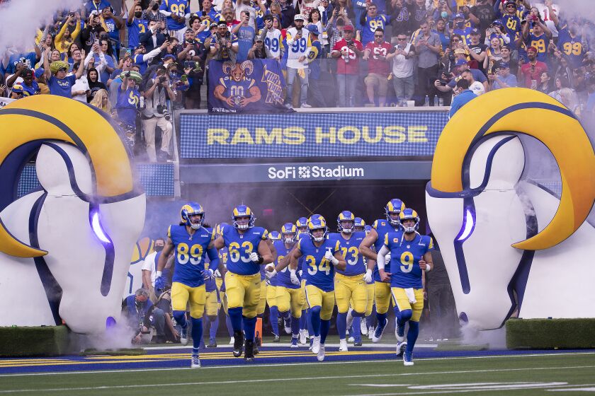 Los Angeles, CA - January 30: Fans cheer as Rams quarterback Matthew Stafford, #9, right, and teammates take the field to play the San Francisco 49ers in the NFC Championships at SoFi Stadium on Sunday, Jan. 30, 2022 in Los Angeles, CA. Rams won 20-17 to earn a berth in the Super Bowl against the Bengals. (Allen J. Schaben / Los Angeles Times)