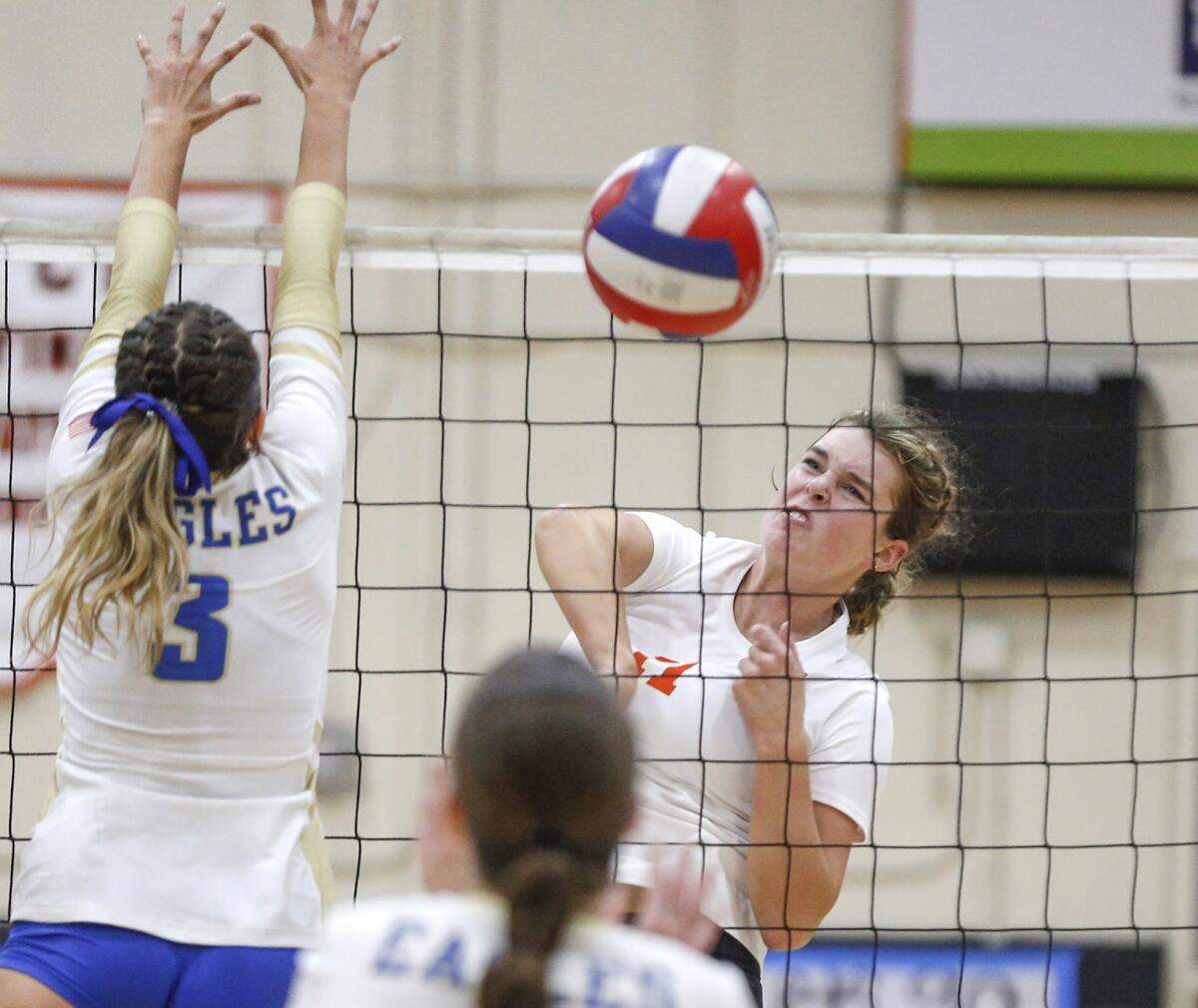 Haylee LaFontaine (11) of Huntington Beach kills a ball past a block during a nonleague match on Tuesday.