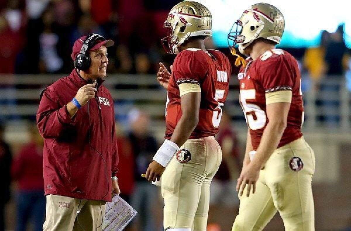 Coach Jimbo Fisher and quarterback Jameis Winston, center, led Florida State to a 41-14 rout of Miami on Saturday to help vault the Seminoles to No. 2 in the BCS standings.