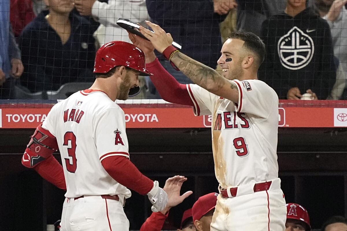 Zach Neto places an illuminated halo on Taylor Ward after Ward hit a solo home run in the seventh inning.