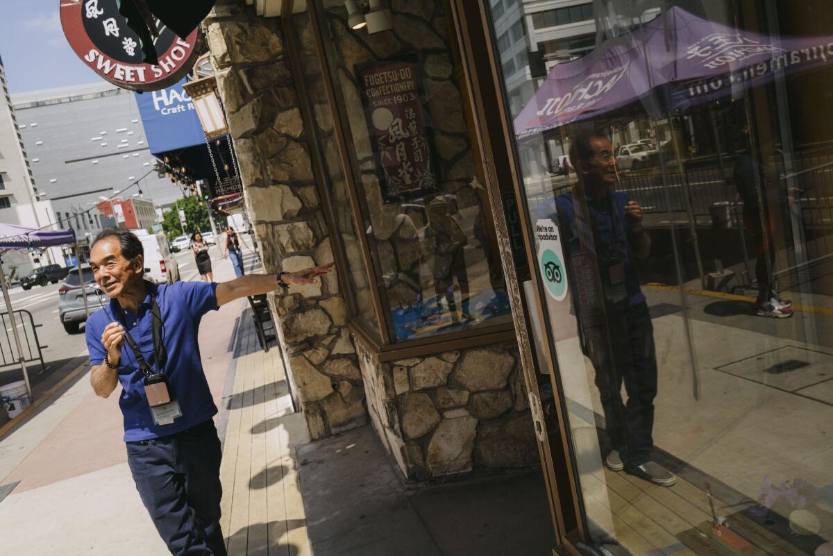 Michael Okamura walks past the historic Fugetsu-Do Sweet Shop.