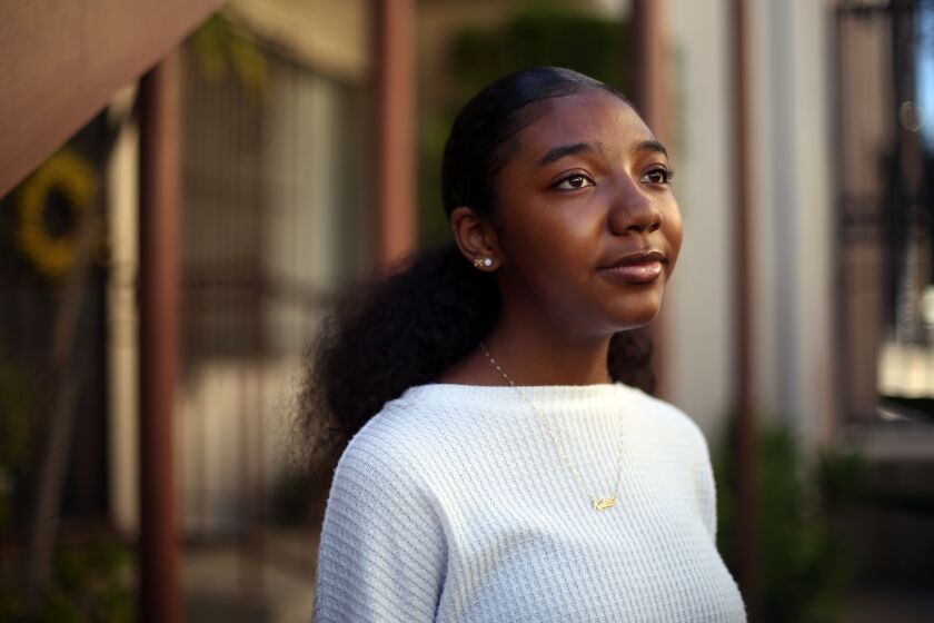 LOS ANGELES, CA - JULY 13: Kahlila William, 16, poses for a portrait the apartment complex where she has lived for the last 6 years in on Monday, July 13, 2020 in Los Angeles, CA. She will be a senior at Girls Academic Leadership Academy and feels going back to school in the fall would be unsafe and she is enjoying time at home with family and the flexibility to be involved in activism and protests that she is passionate about. (Dania Maxwell / Los Angeles Times)