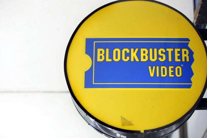 A round, yellow-and-blue Blockbuster Video store sign