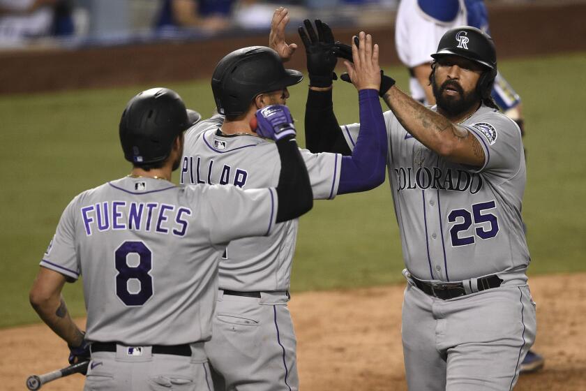 Colorado Rockies designated hitter Matt Kemp, from right to left, celebrates with Kevin Pillar and Josh Fuentes.