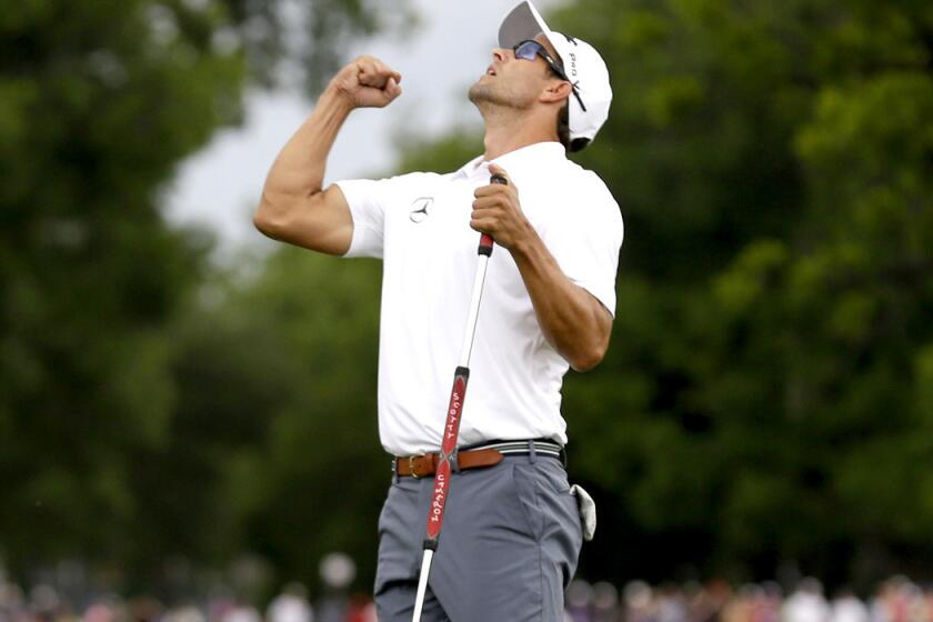 Adam Scott begins to celebrate after sinking the winning putt on the third playoff hole at Colonial on Sunday.