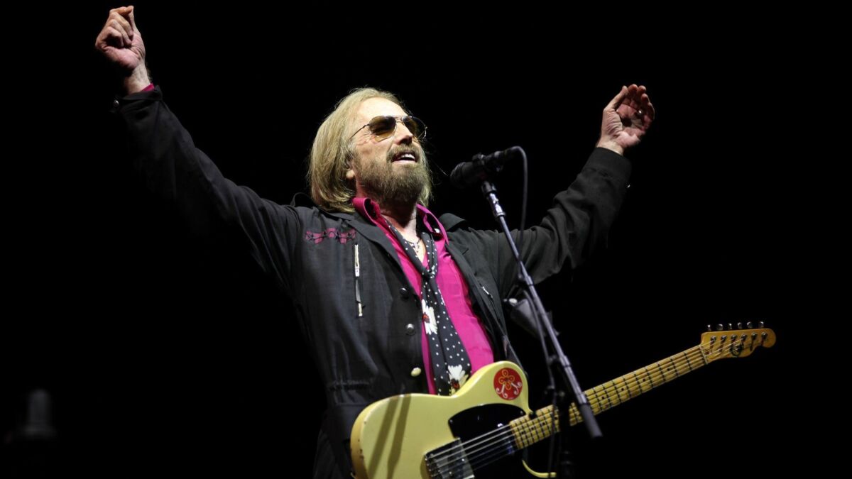 In this file photo from Sept. 17, 2017, Tom Petty leads his band, the Heartbreakers, in a performance at the KAABOO music festival in Del Mar.
