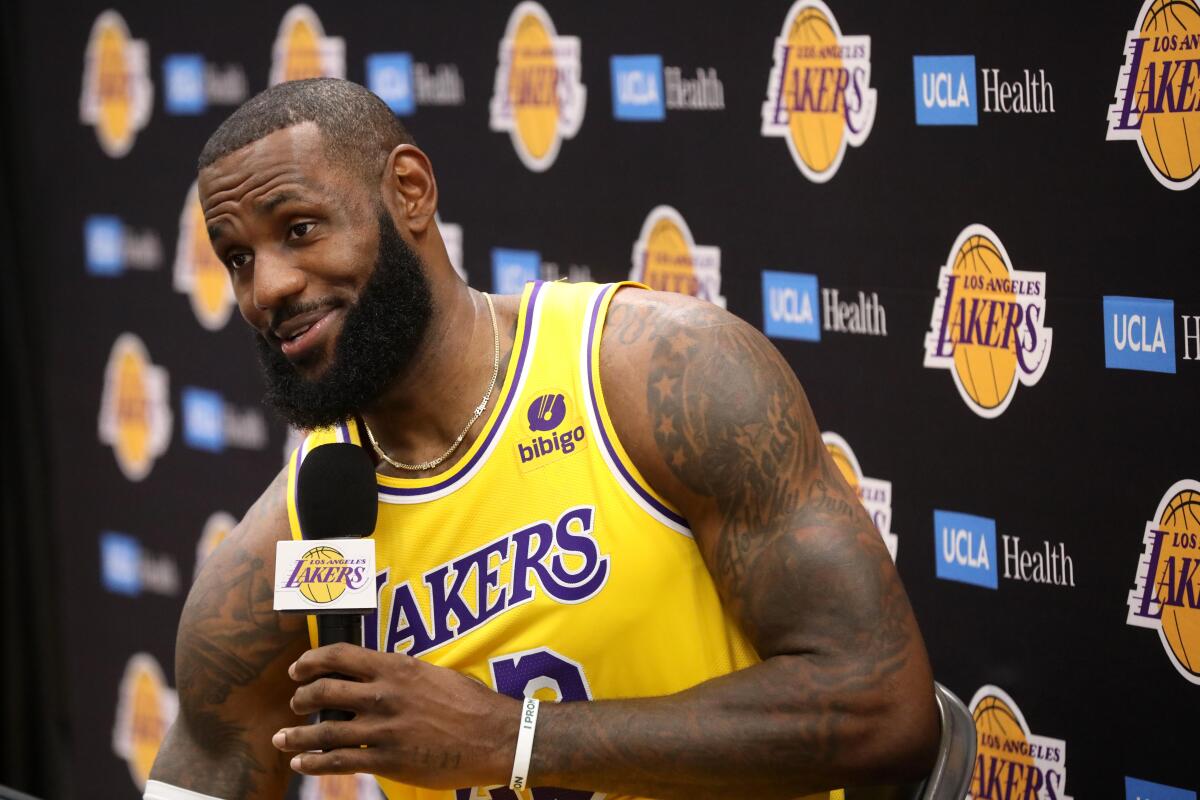 Lakers star LeBron James holds the microphone in his left hand as he addresses the media on Monday.