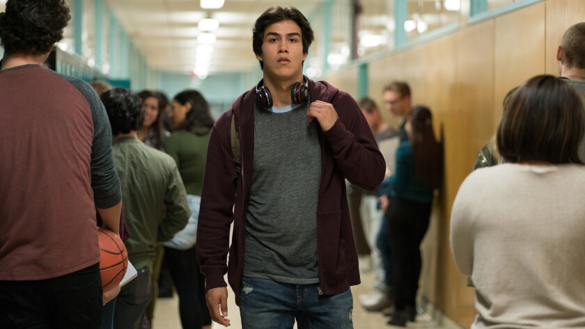 Joel Oulette walks down a school hallway in "Trickster."