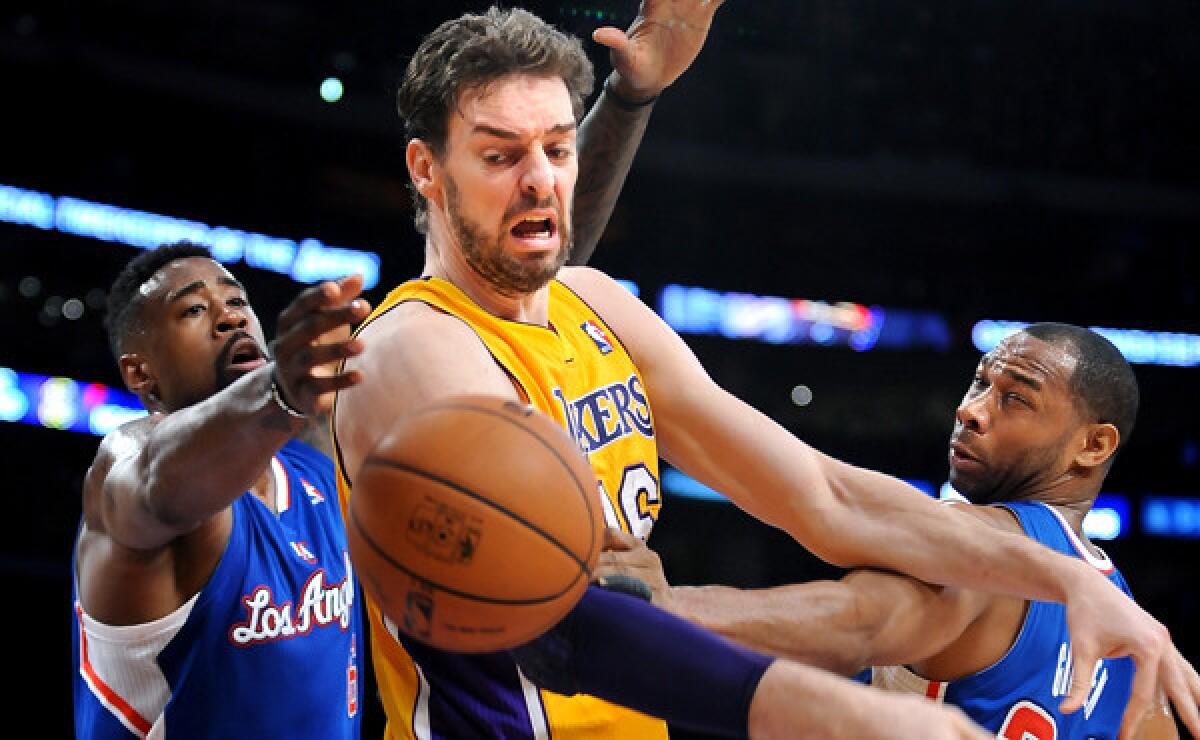 Lakers center Pau Gasol, middle, loses control of the ball in front of Clippers teammates DeAndre Jordan, left, and Willie Green during the Lakers' 142-94 loss March 6. One longtime Lakers fan has grown weary of the team's problems on and off the court.